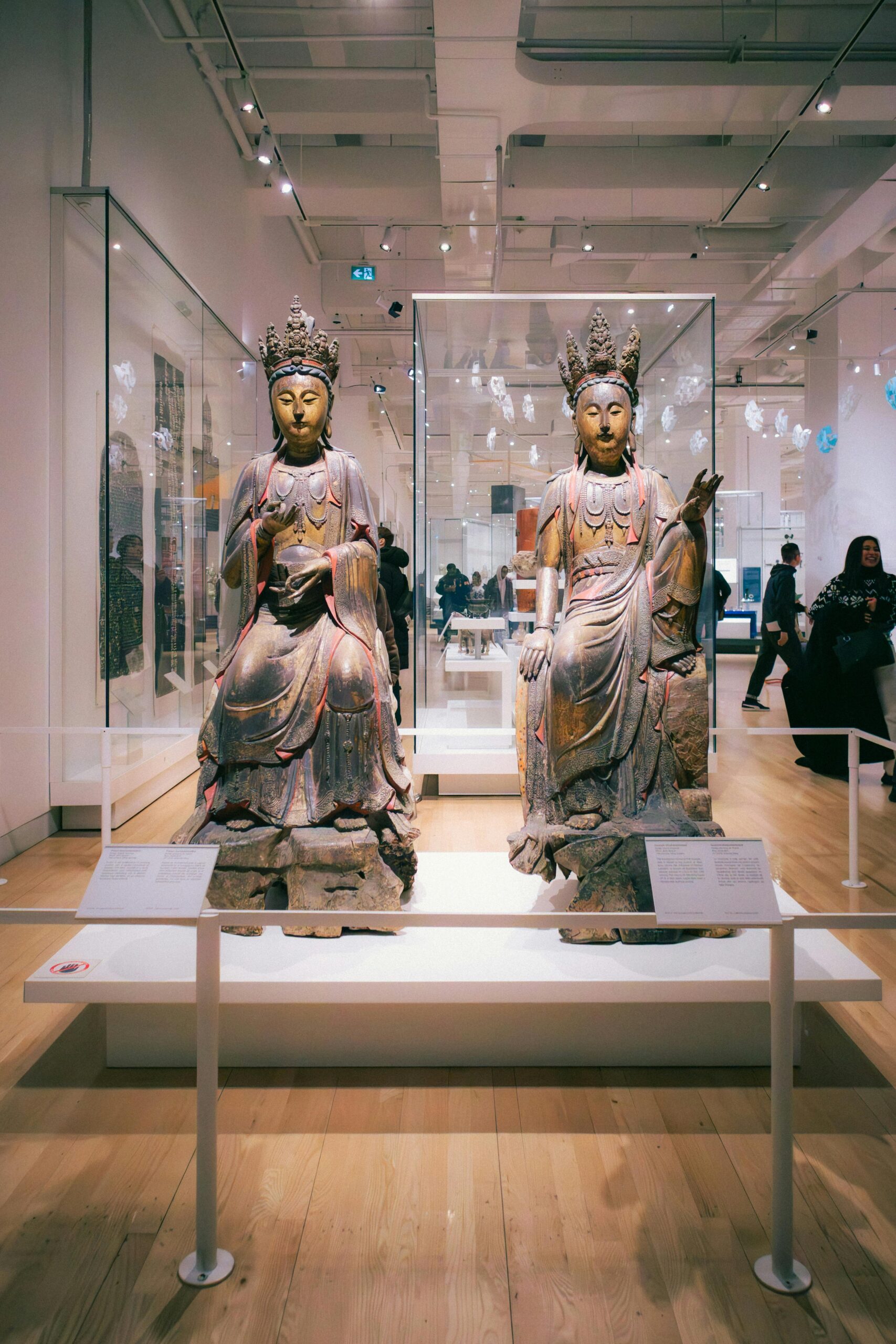 Buddhist statues on display at a museum in Toronto, showcasing historic Chinese culture.